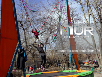 ODESA, UKRAINE - MARCH 27, 2022 - A child jumps on a trampoline in a local zoo that resumed its work, Odesa, southern Ukraine (