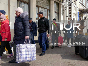 ODESA, UKRAINE - MARCH 29, 2022 - Evacuees from Mykolayiv carry luggage to the station upon their arrival to Odesa, southern Ukraine (