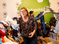 A Ukrainian refugee volunteer, Ania sorts clothes in PSL office in Krakow, Poland where U-Work Foundation provides free goods for war escape...
