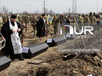 DNIPRO, UKRAINE - APRIL 1, 2022 - Priests officiate the funerals of soldiers killed during the Russian invasion of Ukraine, Dnipro, central...
