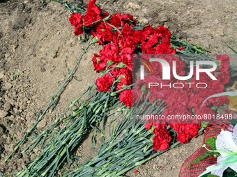 DNIPRO, UKRAINE - APRIL 1, 2022 - Red carnations lie on the grave during the funerals of soldiers killed during the Russian invasion of Ukra...