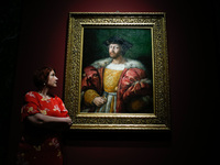 A gallery employee poses with oil on canvas painting 'Lorenzo De' Medici, Duke Of Urbino', dating from 1518 by Italian Renaissance artist Ra...