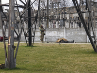 Ukrainian serviceman stands near a body of civilian in the recaptured by the Ukrainian army Bucha city near Kyiv, Ukraine, 04 April 2022. (