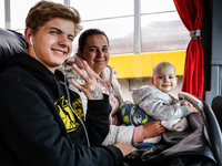 A Ukrainian refugee family sits in a coach of Abdar Polish travel agency at Medyka Ukrainian-Polish border on April 5, 2022. As the Russian...