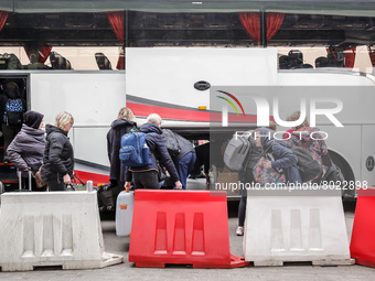 Ukrainian refugees board a coach at the Medyka Ukrainian-Polish border as they travel with the Abdar travel agency from Lviv to Krakow, Pola...