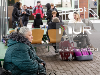 A Ukrainian woman sits on a banch at Medyka Ukrainian-Polish border as she travels with Abdar travel agency from Lviv to Krakow, Poland on A...