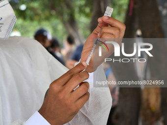 A health system officer prepares a dose of anti-Covid-19 vaccine in the sector of La Parada, near the city of Cúcuta on the Colombian-Venezu...