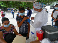 A health system personnel applies a dose of anti-Covid-19 vaccine to a child in the La Parada sector, near the city of Cucuta on the Colombi...