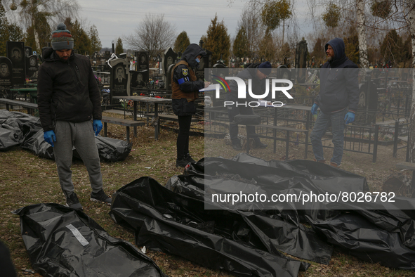 (EDITORS NOTE: Image contains graphic content) Police officers and forensic personnel check to identify the bodies of killed people, who wer...