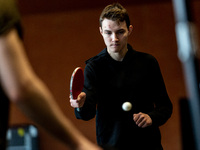 Jaroslav from Kyiv, a Ukrainian young man attends table tenis training run by a trainer Krzysztof in KS Cracovia sports hall in Krakow, Pola...