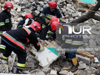 KYIV REGION, UKRAINE - APRIL 06, 2022 - Rescuers clear the debris at the site of a multi-story residential building destroyed by the russian...