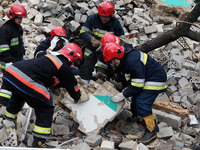 KYIV REGION, UKRAINE - APRIL 06, 2022 - Rescuers clear the debris at the site of a multi-story residential building destroyed by the russian...