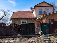 BUCHA, UKRAINE - APRIL 7, 2022 - A damaged fence seals off a house after the liberation of the city from Russian invaders, Bucha, Kyiv Regio...