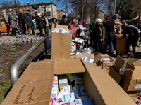 BUCHA, UKRAINE - APRIL 7, 2022 - People queue to receive humanitarian aid after the liberation of the city from Russian invaders, Bucha, Kyi...