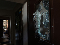 BUCHA, UKRAINE - APRIL 7, 2022 - A broken glass pane inside a door is pictured inside an apartment building after the liberation of the city...