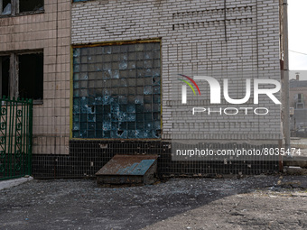 BUCHA, UKRAINE - APRIL 7, 2022 - Bullet holes dot a building at a facility after the liberation of the city from Russian invaders, Bucha, Ky...
