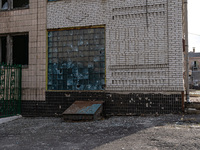 BUCHA, UKRAINE - APRIL 7, 2022 - Bullet holes dot a building at a facility after the liberation of the city from Russian invaders, Bucha, Ky...