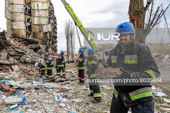 Rescuers conduct a search and rescue operation at the wreckage of a devastated residential apartment by Russian airstrikes in Borodyanka, Bu...