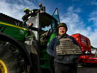 ZAPORIZHZHIA REGION, UKRAINE - APRIL 08, 2022 - An agrarian wears a bulletproof vest  during the sowing which takes place 30 km from the fro...