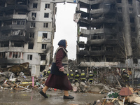The woman goes past Residential building Destroyed by Russian army in Borodyanka city near Kyiv, Ukraine, 09 April 2022 (