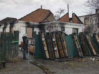 Boxes from ammunition next to Residential houses Destroyed by Russian army in the recaptured by the Ukrainian army Andriivka village, Kyiv r...
