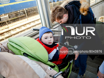 UZHHORORD, UKRAINE - APRIL 08, 2022 - A man with a baby in a pram is seen at the railway station, Uzhhorod, western Ukraine (