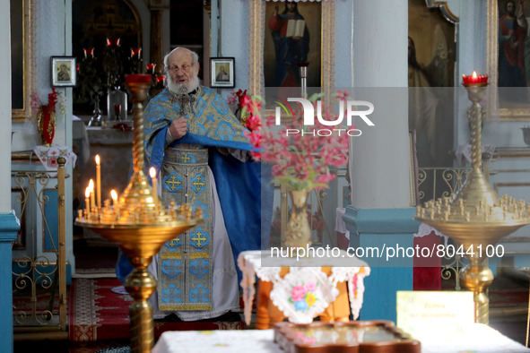 KYIV REGION, UKRAINE - APRIL 07, 2022 - A priest conducts a church service in one of the settlements affected by the russian military invasi...