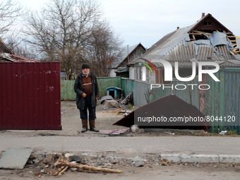 KYIV REGION, UKRAINE - APRIL 07, 2022 - A man stands by the house damaged in the result of the russian military invasion, Borodyanka, Kyiv R...