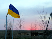 KYIV REGION, UKRAINE - APRIL 07, 2022 - Ukrainian national flag flutters in the wind in one of the liberated settlements of the Kyiv Region,...
