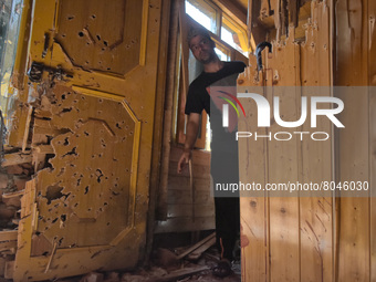 A Kashmiri man assess the damaged residential house in Srinagar, Indian Administered Kashmir on 10 April 2022. Two foreign militants were ki...