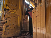 A Kashmiri man assess the damaged residential house in Srinagar, Indian Administered Kashmir on 10 April 2022. Two foreign militants were ki...