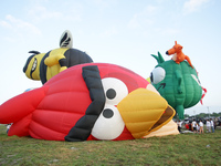 Hot air balloons are inflated as it gets ready for take-off at the Philippine International Hot Air Balloon Festival on April 11, 2014. The...