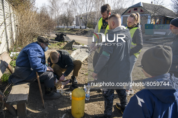 Medic Volunteer provides medical assistance to the local resident in Andriyivka village,  close to Kyiv, Ukraine, Monday, April 11, 2022 