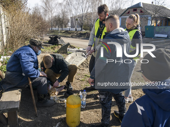 Medic Volunteer provides medical assistance to the local resident in Andriyivka village,  close to Kyiv, Ukraine, Monday, April 11, 2022 (