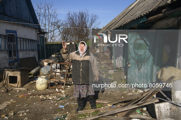 Local resident Nadia reacts as she stands near her destroyed and robbed by Russian army house in Andriyivka village,  close to Kyiv, Ukraine...