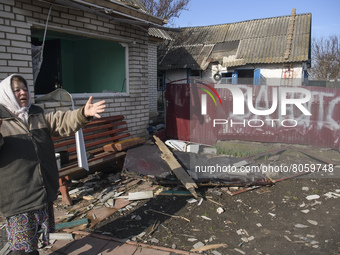 Local resident Nadia reacts as she stands near her destroyed and robbed by Russian army house in Andriyivka village,  close to Kyiv, Ukraine...