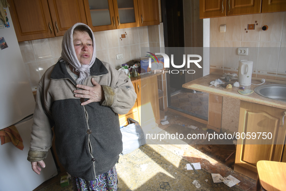 Local resident Nadia reacts as she stands in her destroyed and robbed by Russian army house in Andriyivka village,  close to Kyiv, Ukraine,...