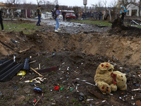 NOVOSELIVKA, UKRAINE - APRIL 9, 2022 - A teddy bear lies in the crater left by a bomb after the liberation of a town from Russian invaders,...