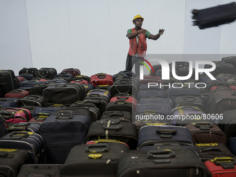  A worker arranges luggage during the Operational Readiness and Airport Transfer (ORAT) at the new budget airport KLIA2, in Sepang, Malaysia...