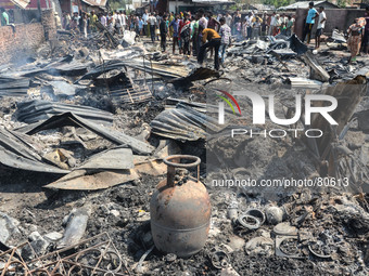 Indian residents salvage their belonging after a fire gutted down many residential houses at Signal Bosti in Dimapur, India north eastern st...
