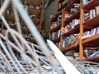 CHERNIHIV, UKRAINE - APRIL 11, 2022 - Books on the shelves are seen inside a library damaged as a result of shelling by Russian troops are p...