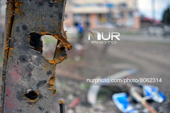CHERNIHIV, UKRAINE - APRIL 11, 2022 - Shrapnel holes dot a fence after the liberation of the city from Russian invaders, Chernihiv, northern...