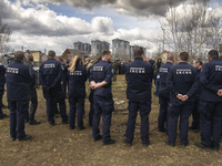 French forensics investigators, who arrived to Ukraine for the investigation of war crimes amid Russia's invasion, stand next to a mass grav...