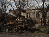 Destroyed cars and houses on one of the streets in the village of Andriyivka, Kyiv region, on April 12, 2022. 
About a month later, the vill...