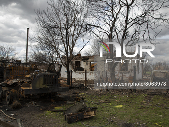 Destroyed cars and houses on one of the streets in the village of Andriyivka, Kyiv region, on April 12, 2022. 
About a month later, the vill...