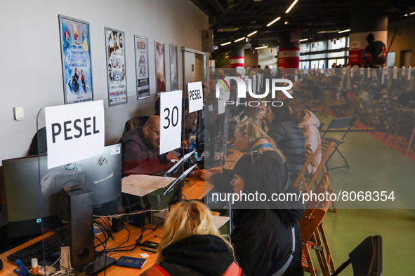 Refugees from Ukraine who fled to Poland after Russian attack are seen at the register point in Tauron Arena to obtain a PESEL national iden...