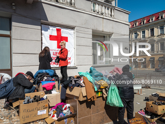 Ukrainian refugees are seen receiving help outside the local school n˚117 converted in the Huanitarian Volunteer Center, in the city center...