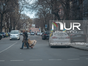 An Ukrainian citizen is seen crossing the streets with cardboards on a trolley, in the streets of the center in Odessa, Ukraine. (