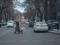 An Ukrainian citizen is seen crossing the streets with cardboards on a trolley, in the streets of the center in Odessa, Ukraine. (