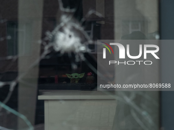 A puppet is seen through a window shot by gunfire, inside an office in the city center of Mykolaiv, Ukraine.(